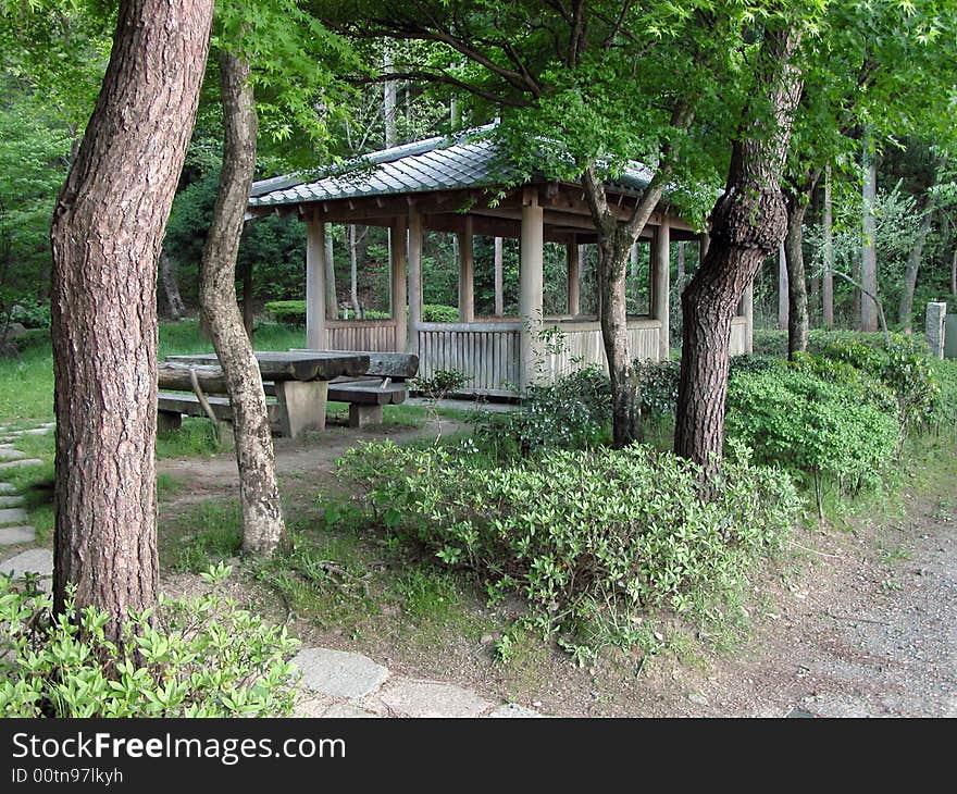 Traditional wooden resting place in a summer Japanese garden