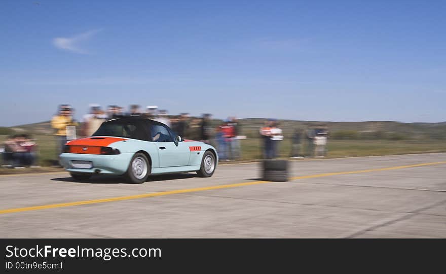 Panning image of a trendy car during a legal street car race.