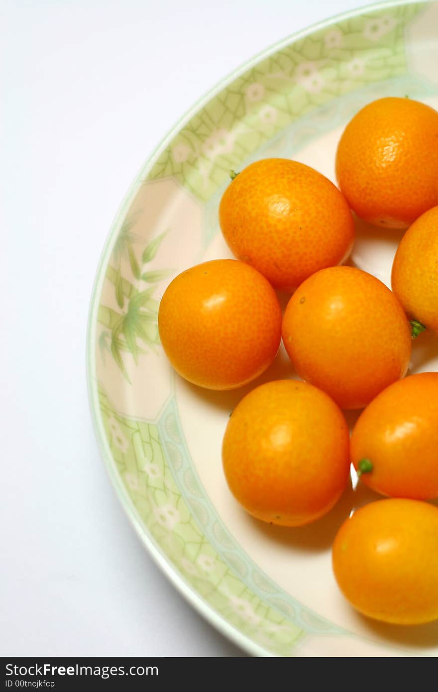 Fresh ripe kumquats on white background