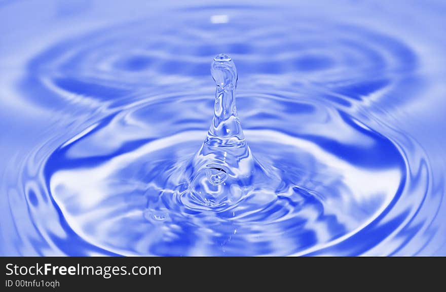 Single blue water drop with little ripples