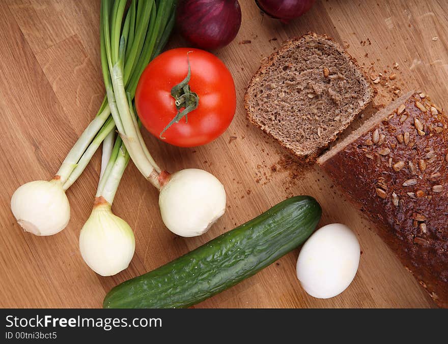 Some vegetables, egg and bread. Some vegetables, egg and bread