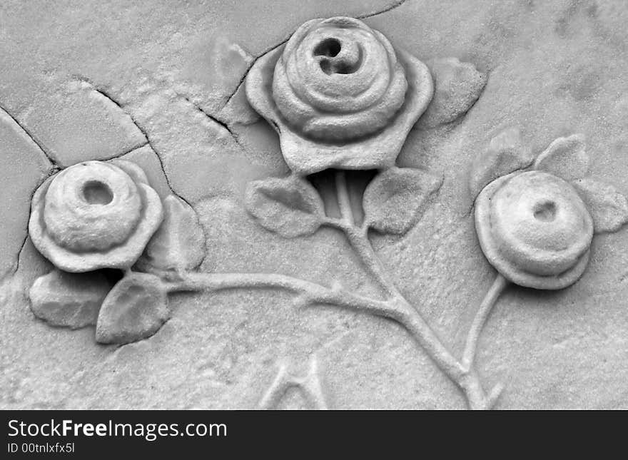 Roses carved into a gravestone in black and white. Roses carved into a gravestone in black and white