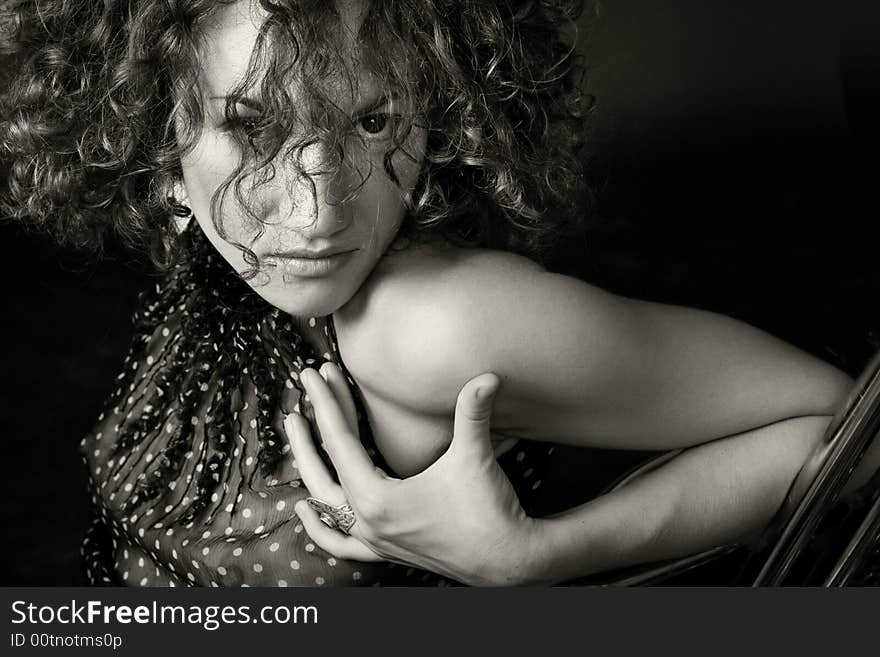 Portrait of a woman in a studio on a dark background