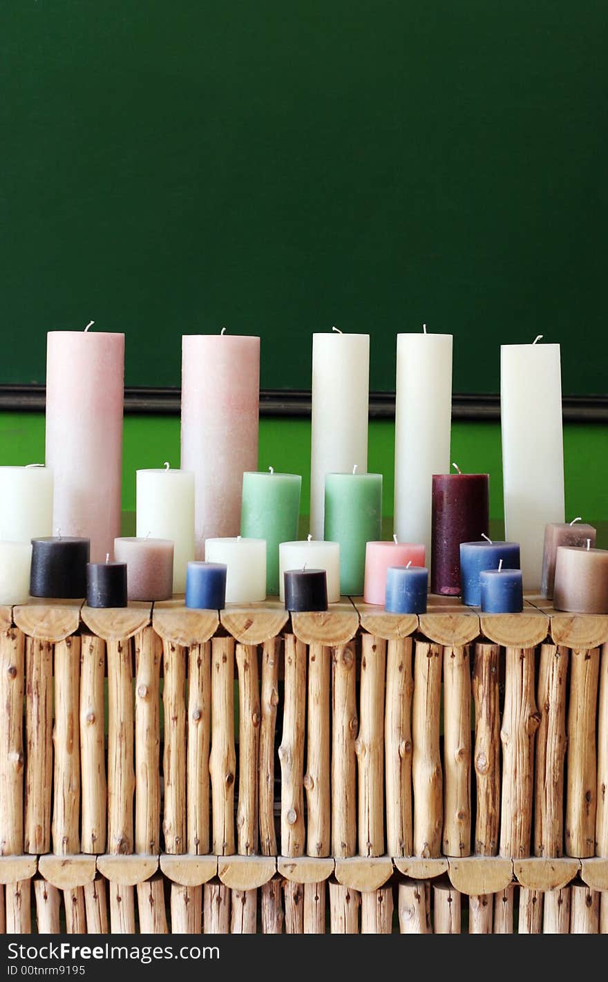 Rows of colorful wax candles on a shelf.