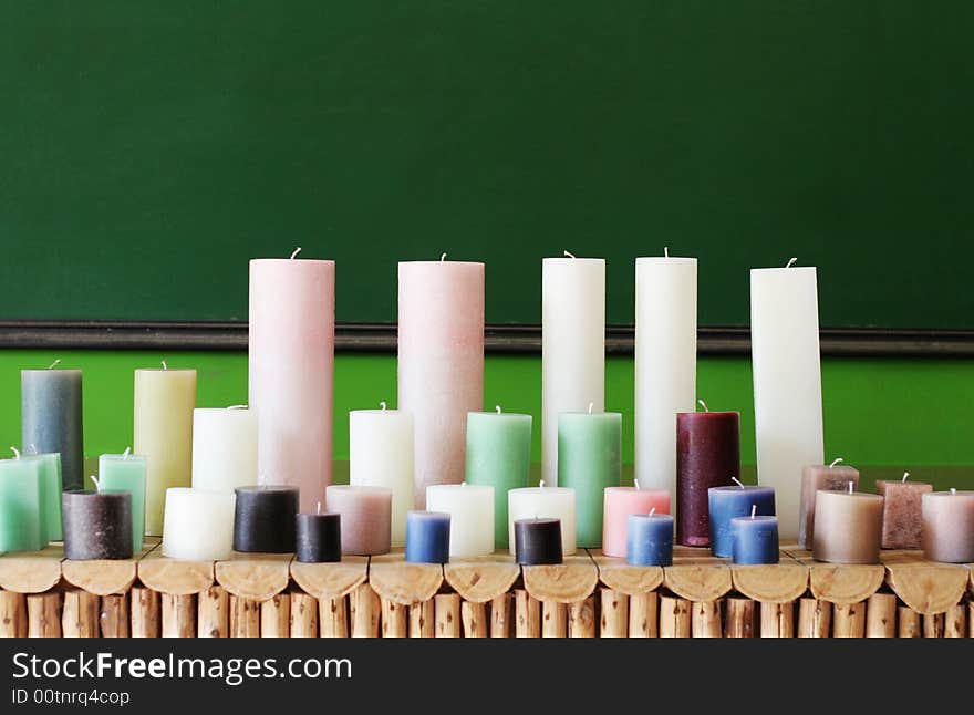 Rows of colorful wax candles on a shelf.