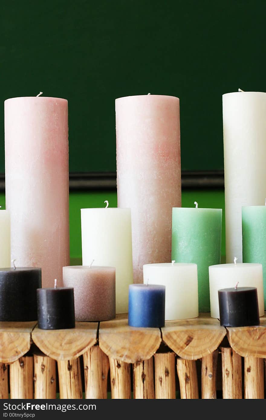 Rows of colorful wax candles on a shelf.