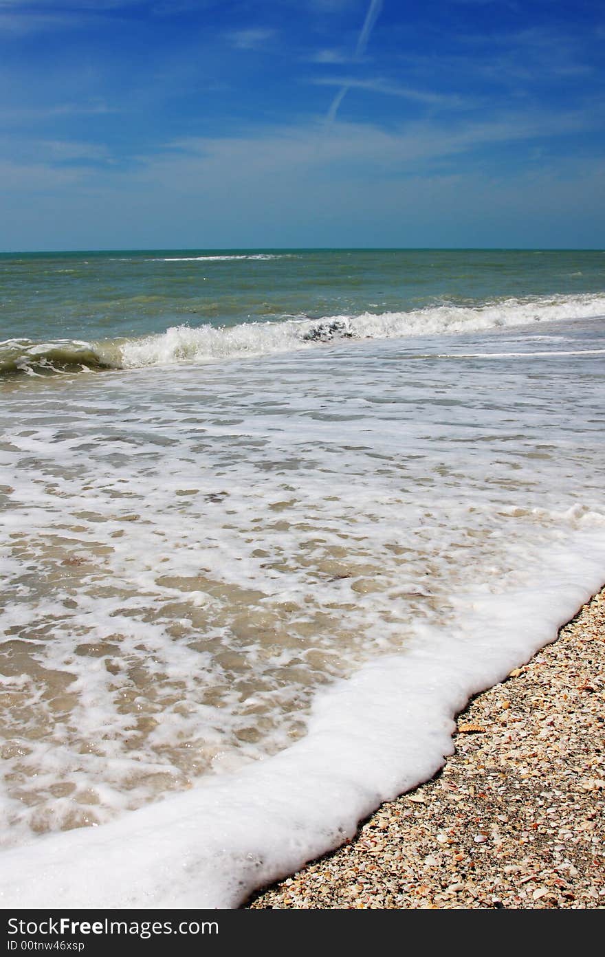 Part of beach with a view on the ocean and a wave. Part of beach with a view on the ocean and a wave