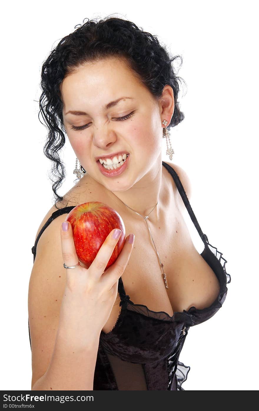 The beautiful girl holds an apple in a hand. The beautiful girl holds an apple in a hand