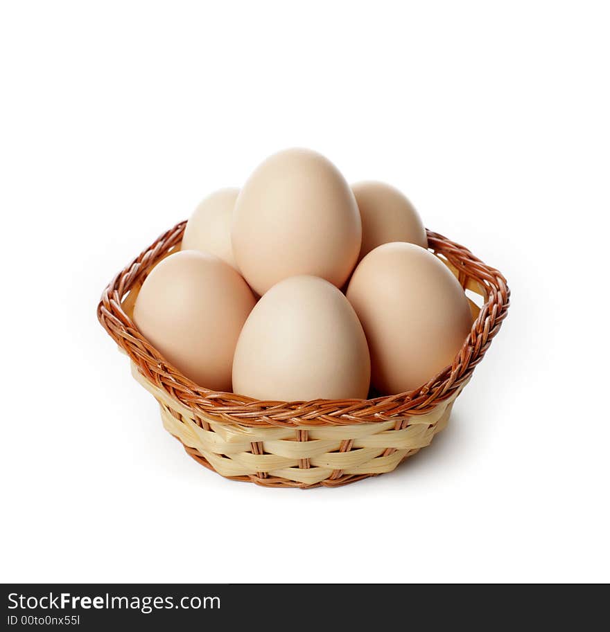 Eggs in basket isolated in white background