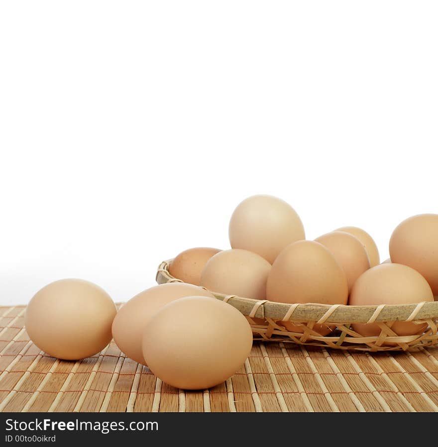 Eggs in basket isolated in white background