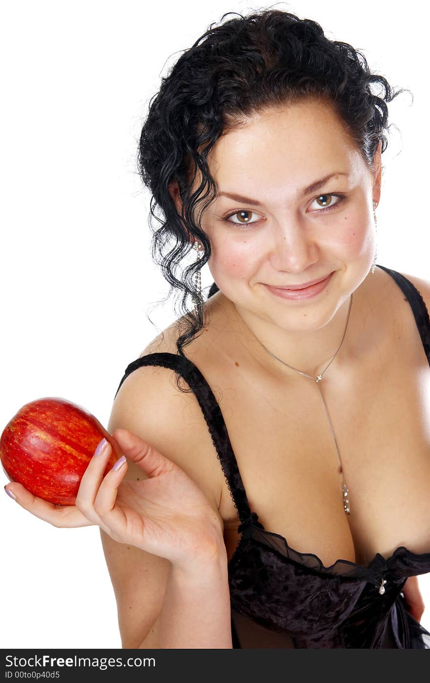 The beautiful girl holds an apple in a hand. The beautiful girl holds an apple in a hand