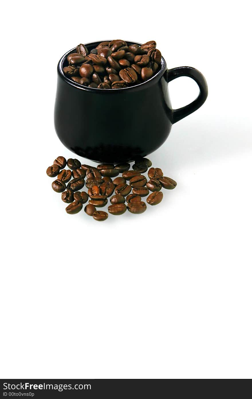 Coffee beans in a little brown cup on a white background. Coffee beans in a little brown cup on a white background