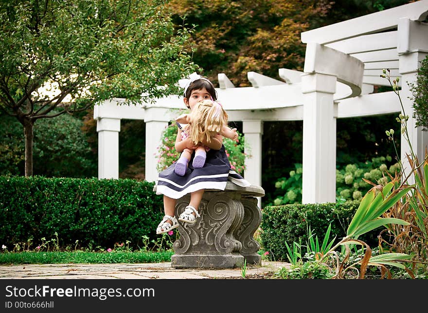 Two year old sitting on grasses with beautiful fall colors in the background. Two year old sitting on grasses with beautiful fall colors in the background