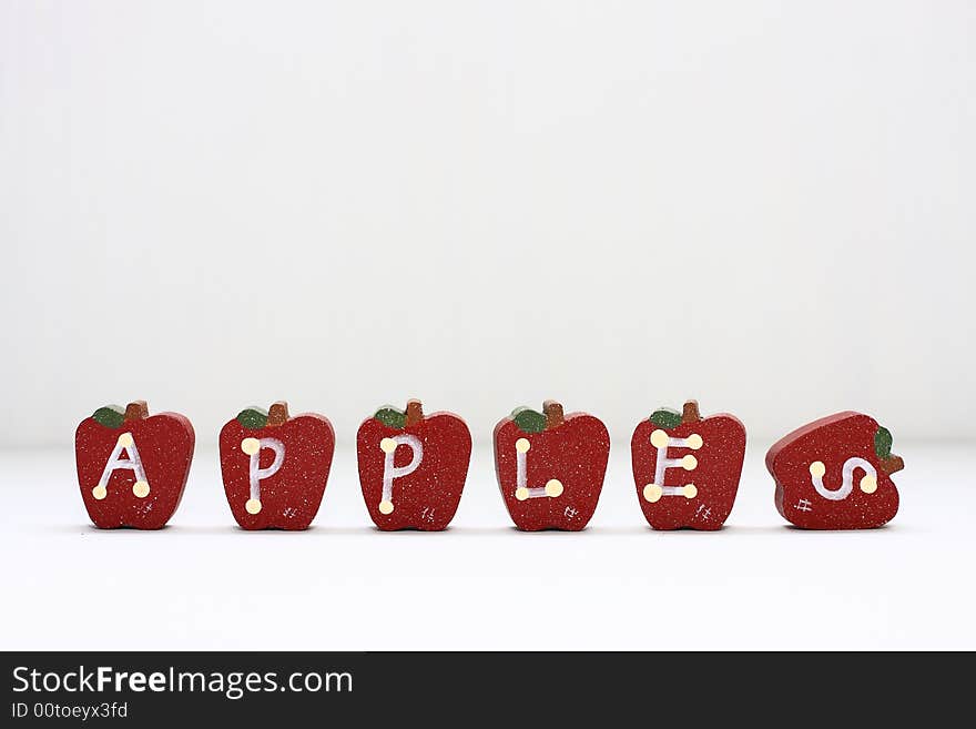 Wooden Apples with letterings spelling apples.