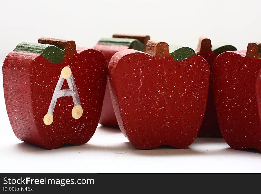 Wooden Apples with the letter A painted on it.