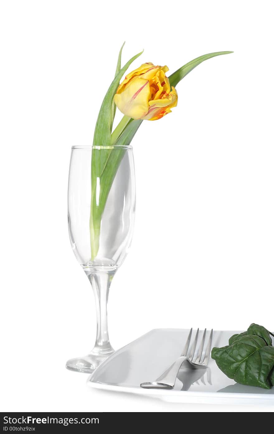 Still life of vegetables on a plete and flower in a glass. Still life of vegetables on a plete and flower in a glass.