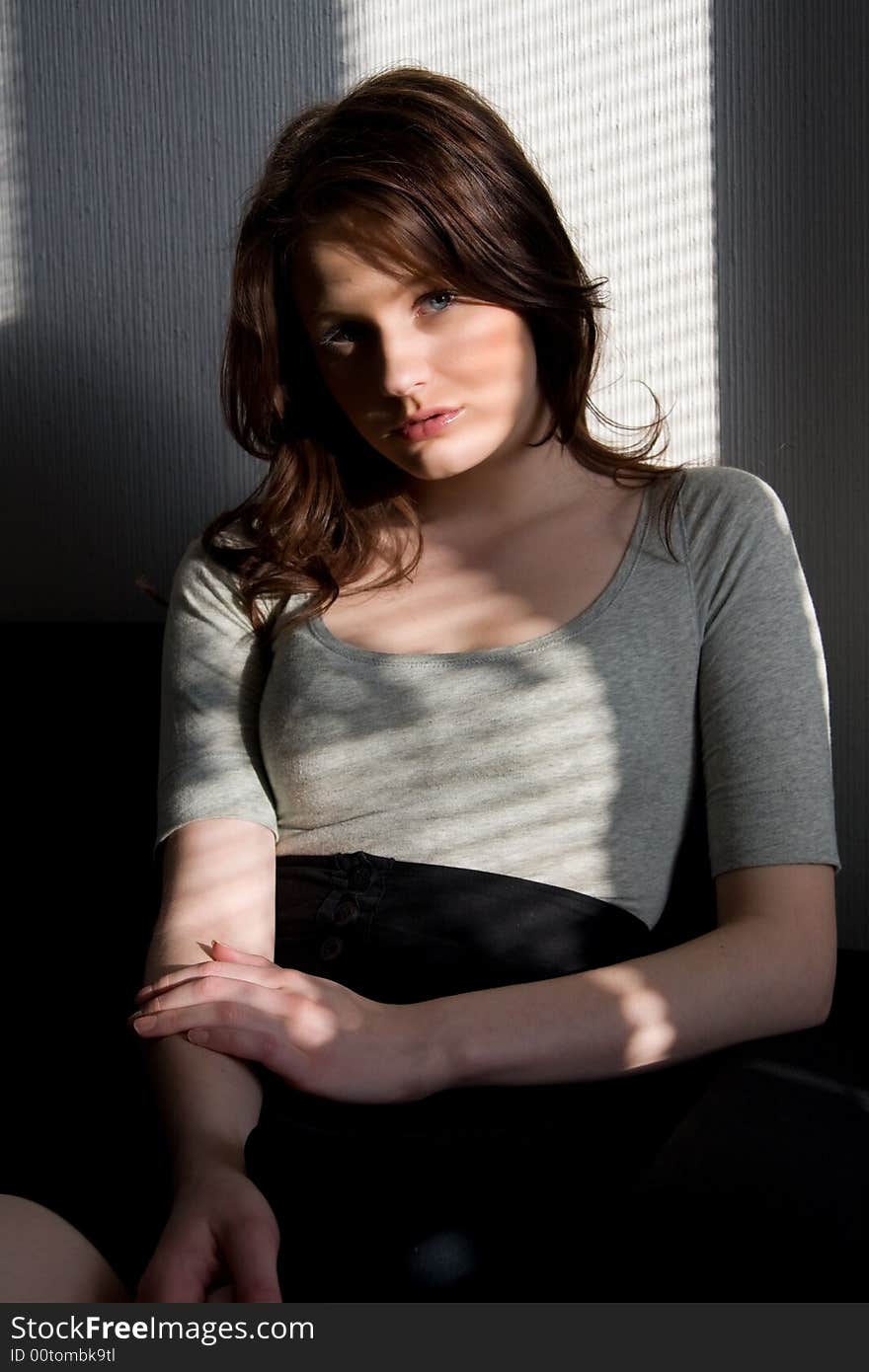 Portrait of young beautiful woman sitting on the sofa