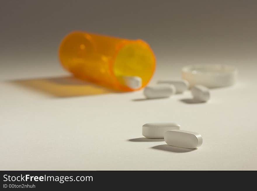 Pills and Fallen Bottle with Dramatic Lighting.