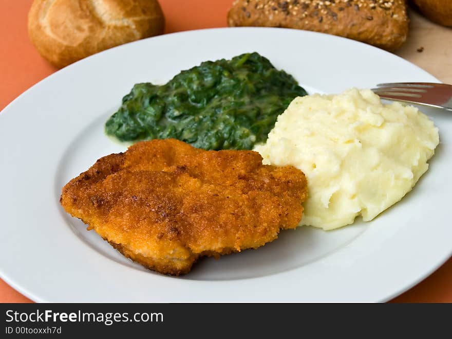 Fried cutlet with spinach and puree.