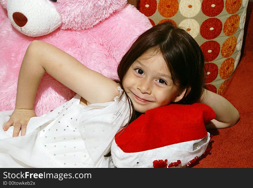 A girl and pink doll smiling. A girl and pink doll smiling