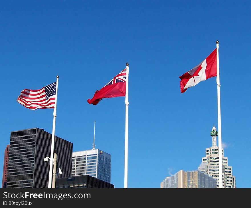 Three flags on the background of blue sky