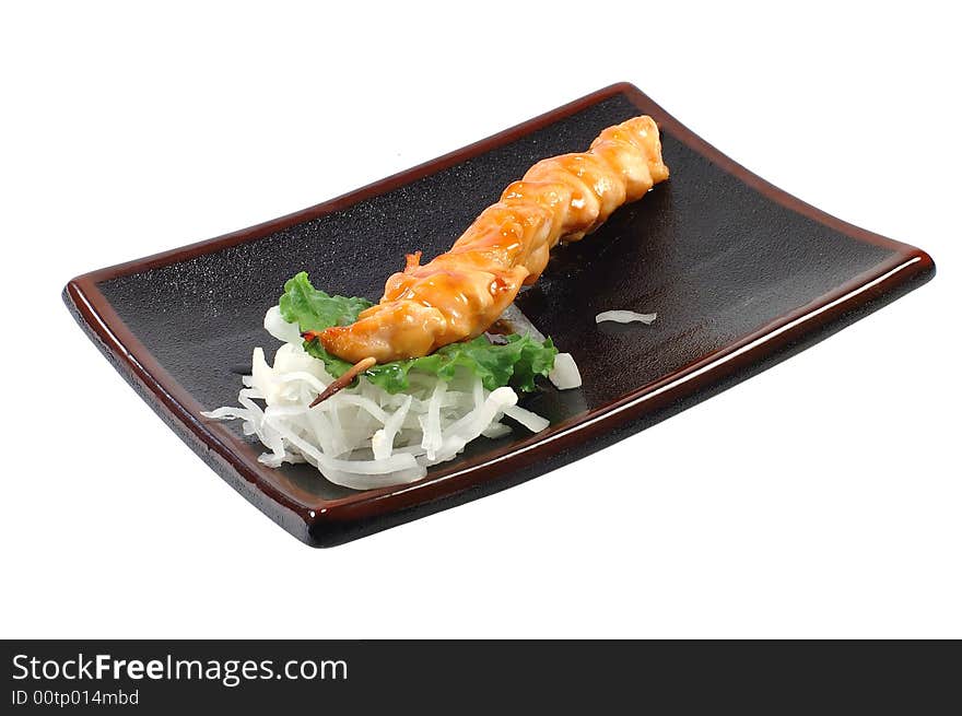 Shish kebab from a salmon on a dish on a white background