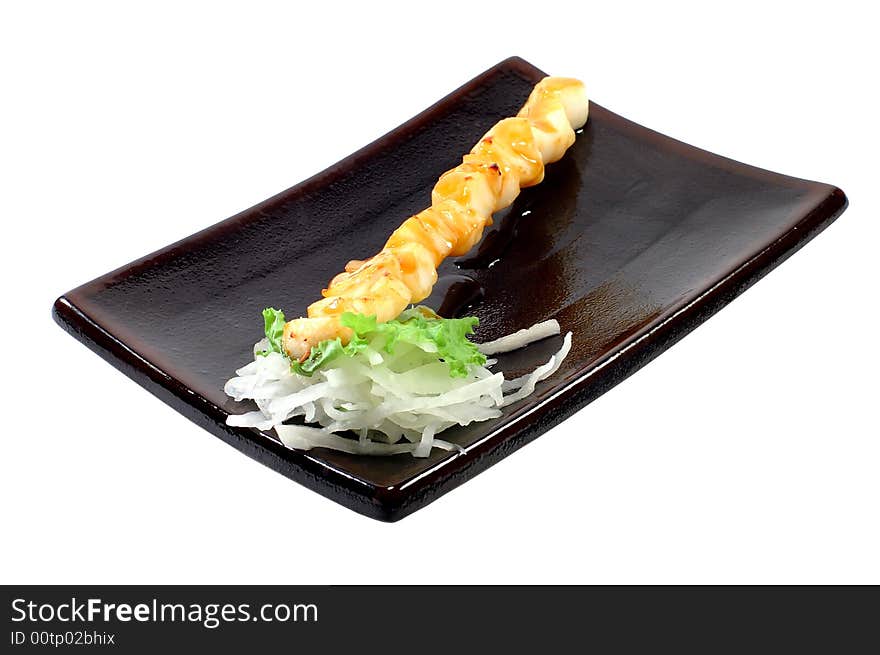 Shish kebab from a salmon on a dish on a white background