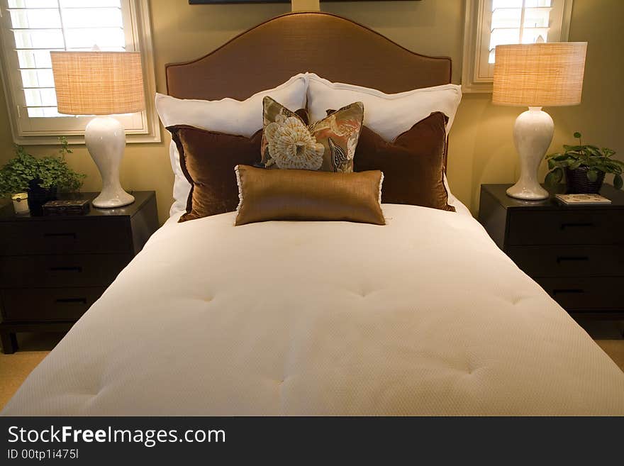 Comfortable bedroom and modern decor in a luxury home. Comfortable bedroom and modern decor in a luxury home.