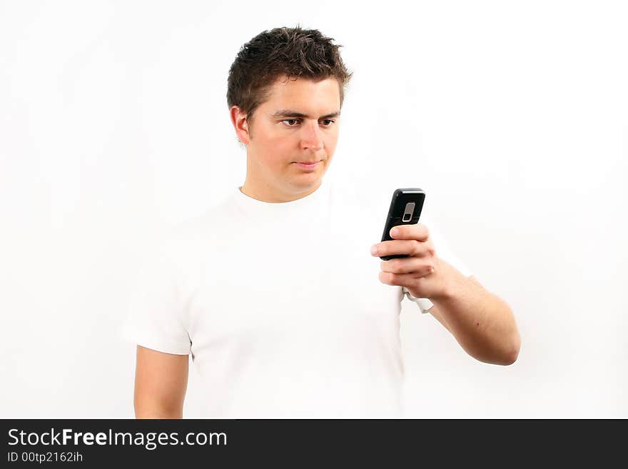 Young man checking the mobile phone over white. Young man checking the mobile phone over white