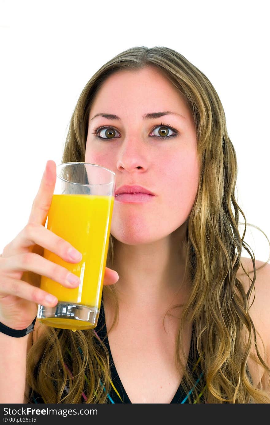 Gorgeous girl with mouthful of orange juice