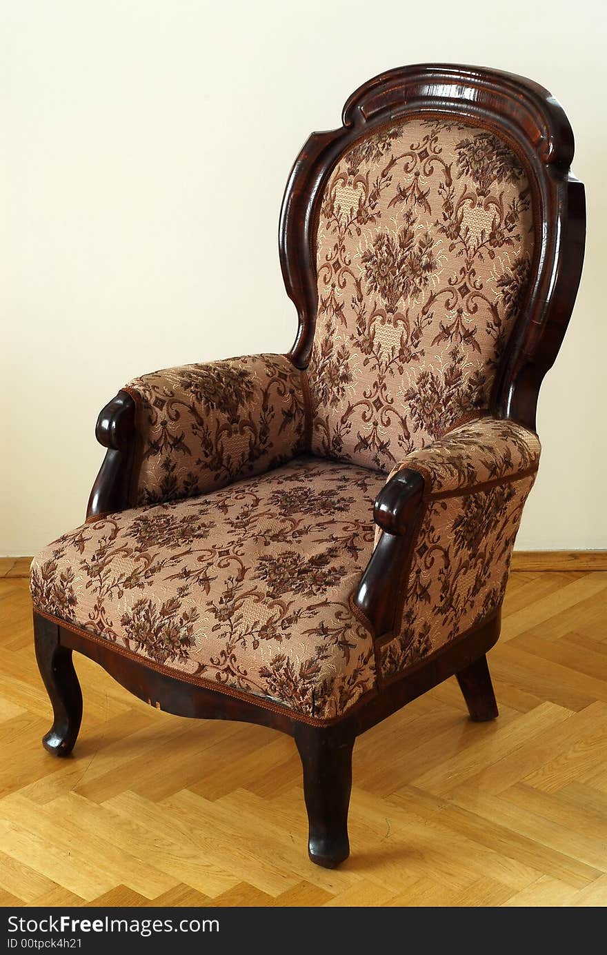 Antic chair at the wooden floor. Brown wood. Light parquet.