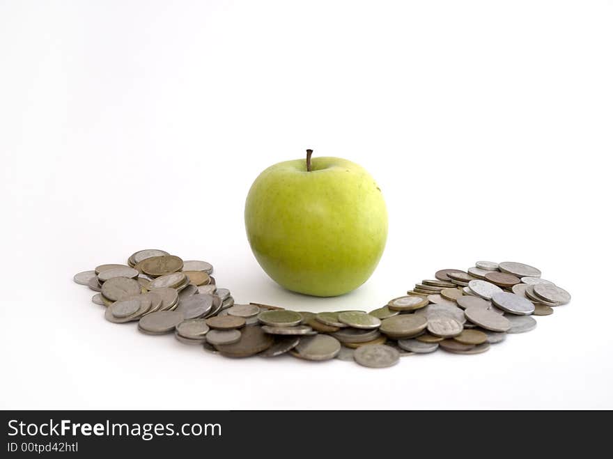 Green apple on the heap of coins