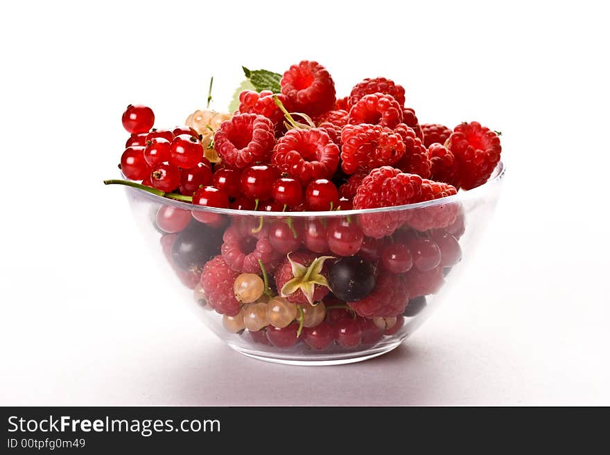 Raspberry and currant on the glassy bowl