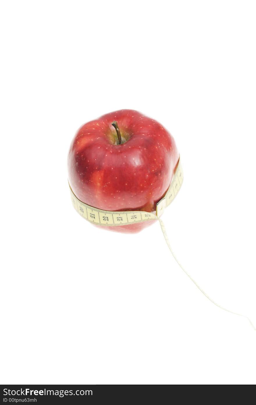 A red apple with measuring tape on its body. A red apple with measuring tape on its body