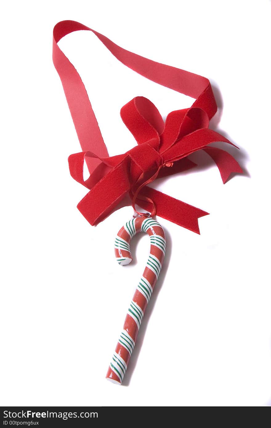 A colorful Candy Cane on a Red Ribbon against a white background. A colorful Candy Cane on a Red Ribbon against a white background