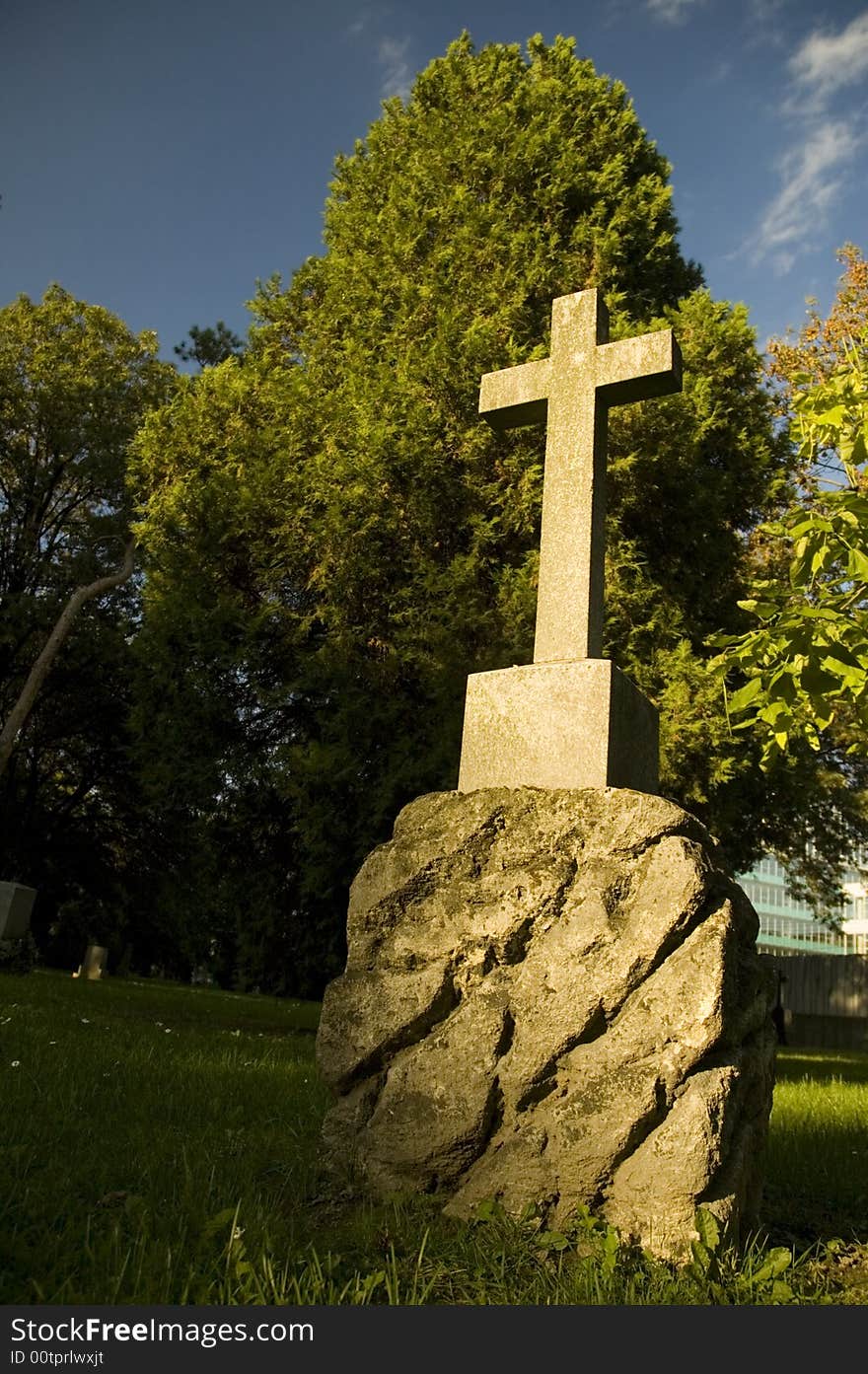 Religious cemetery with fresh green trees and grass