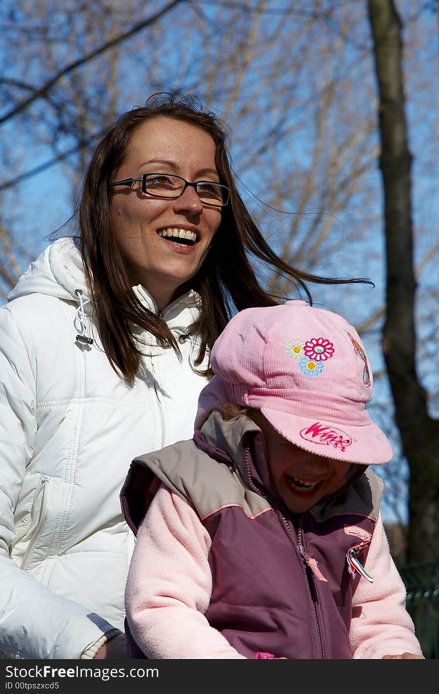 Young girl and children smiling in tandem seesaw.