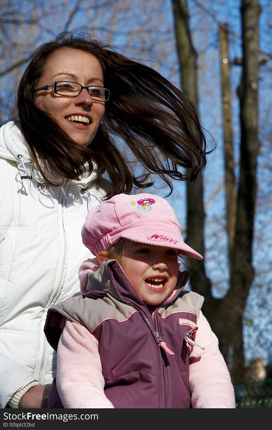 Young girl and children smiling in tandem seesaw.