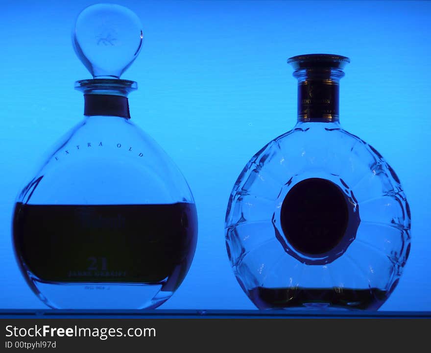 Whisky bottles as contour on a blue lighted background