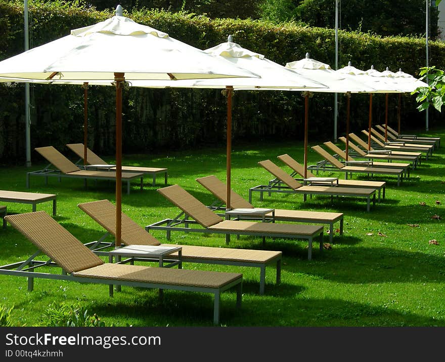 Umbrellas and chairs outside a swimming. Umbrellas and chairs outside a swimming