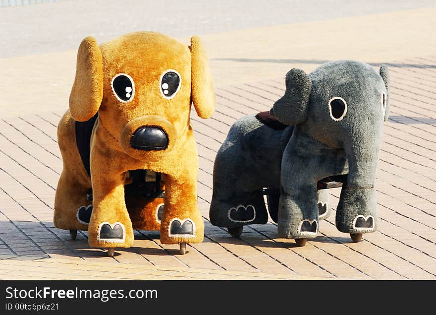 A doggy and elephant baby carriage  on the piazza