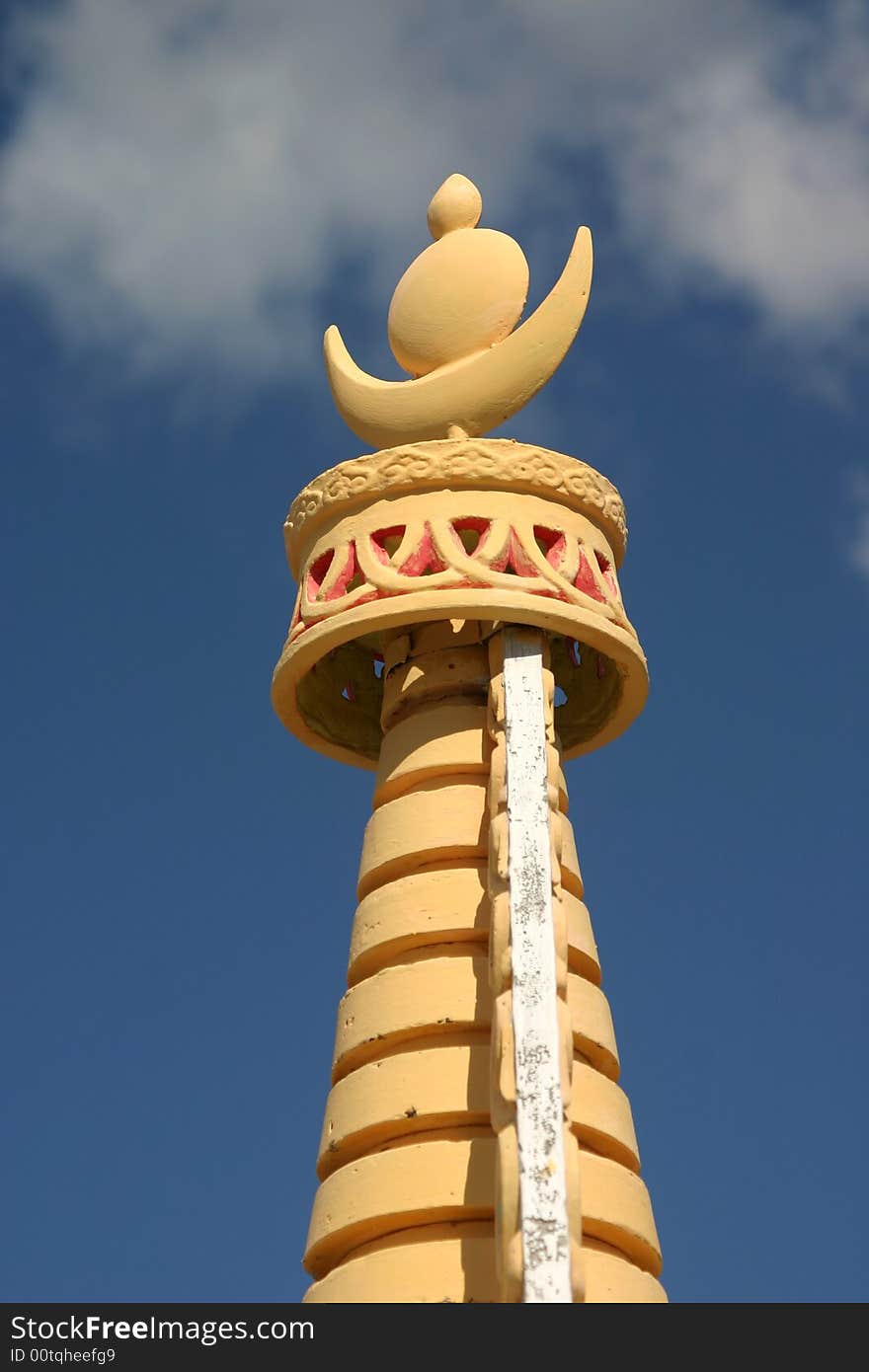 The top of a buddhist stuppa on a blue sky in siberia, symbol of the sun and the moon. The top of a buddhist stuppa on a blue sky in siberia, symbol of the sun and the moon