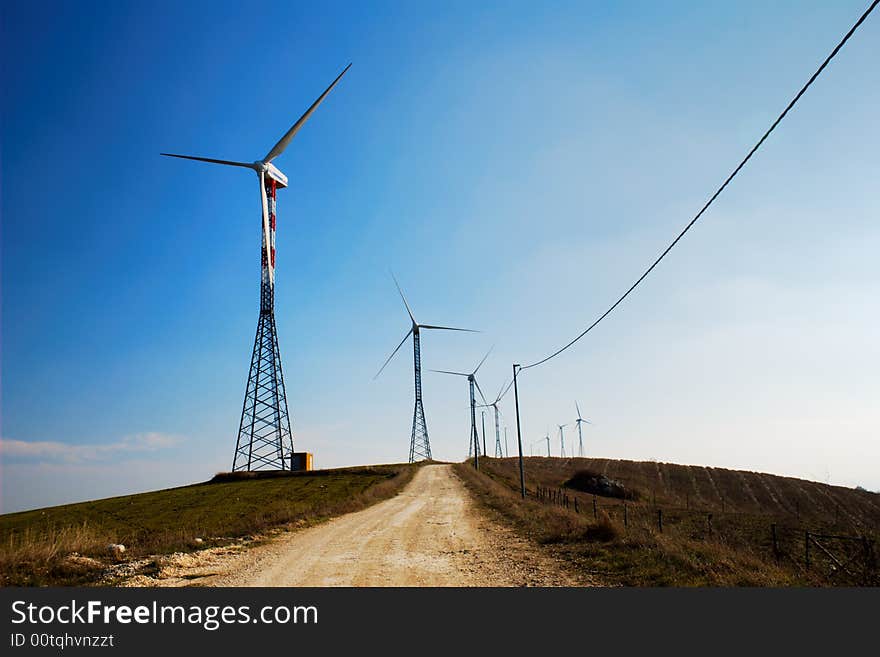 Road through the ecologic generators on top of a hill. Road through the ecologic generators on top of a hill