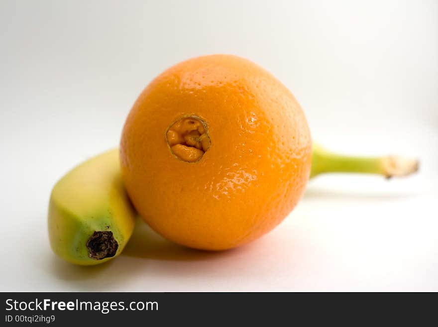 Banana and orange on white background isolated