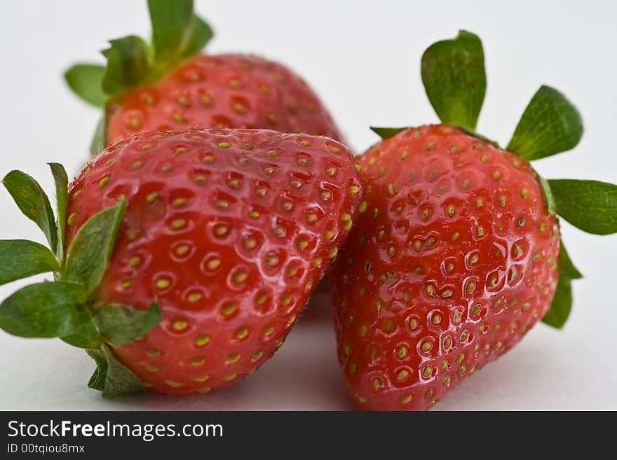 Isolated group of three red ripe strawberries on white background. Isolated group of three red ripe strawberries on white background