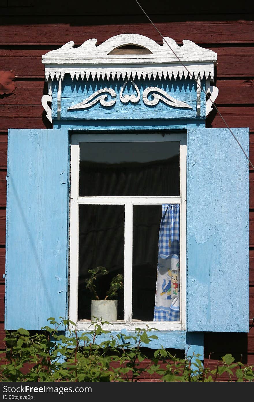 A window and blue shutter of a datcha, traditional home of siberia. A window and blue shutter of a datcha, traditional home of siberia