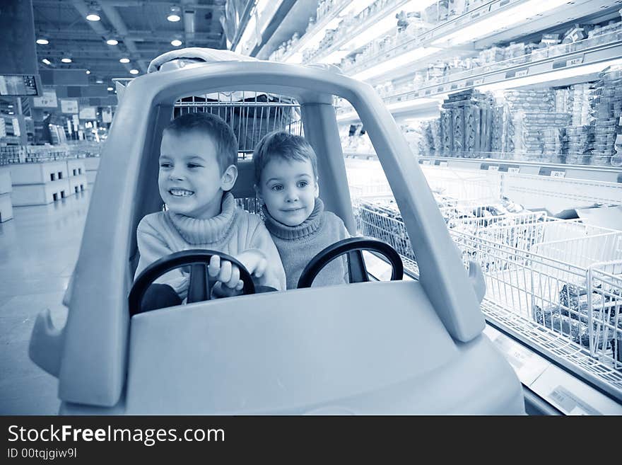 Children in  toy automobile in  supermarket