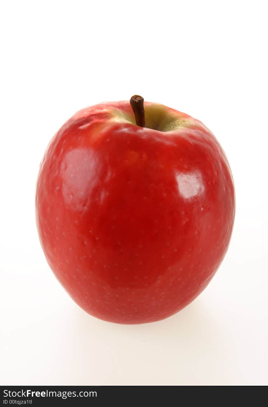 A juicy red shiny apple isolated on white. A juicy red shiny apple isolated on white.