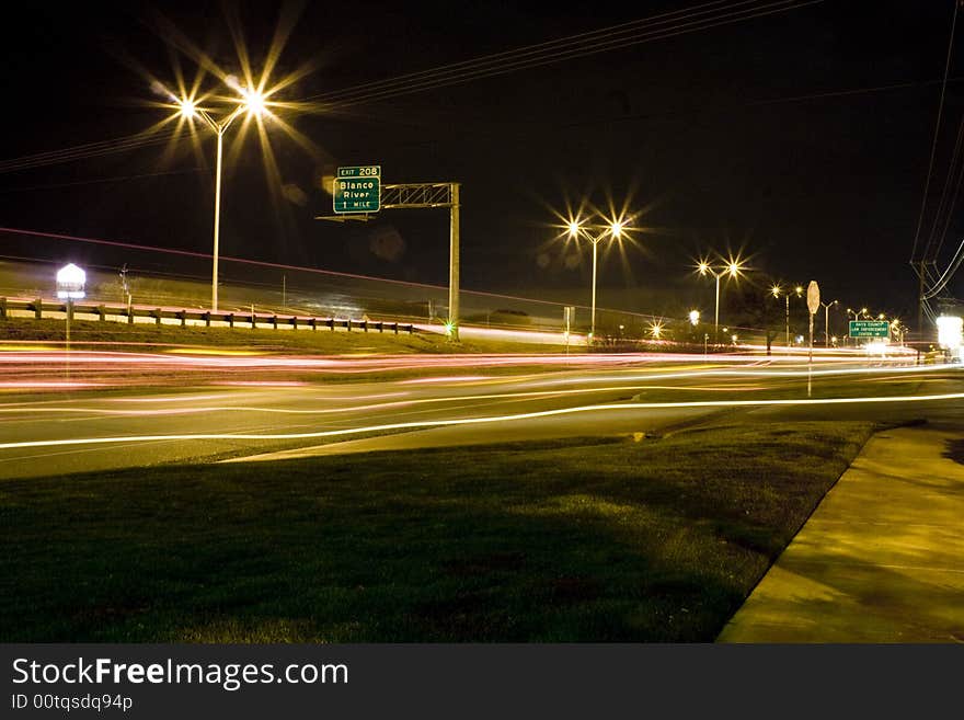 Long camera exposure making streaming lights across the road. Long camera exposure making streaming lights across the road.