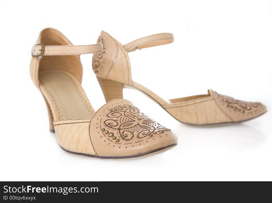 Beige female shoes on a white background